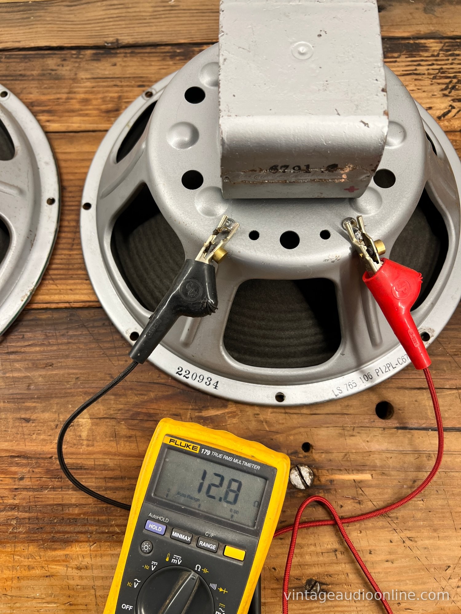 Grey cast-frame 12-inch speaker with an EIA code stamped on the frame