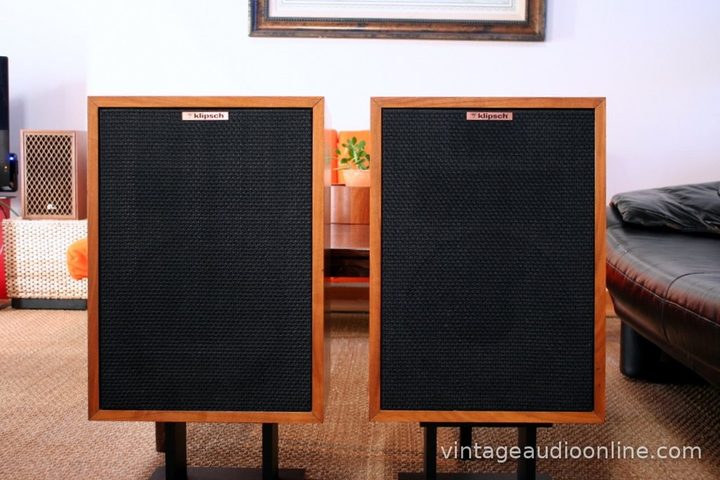 Pair of Klipsch Heresy II speakers with black grilles in a living room